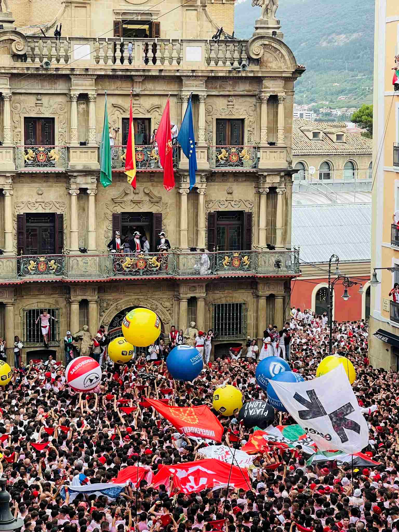 Crowds in front of stone building at San Termini Opening Ceremony, Northern Spain